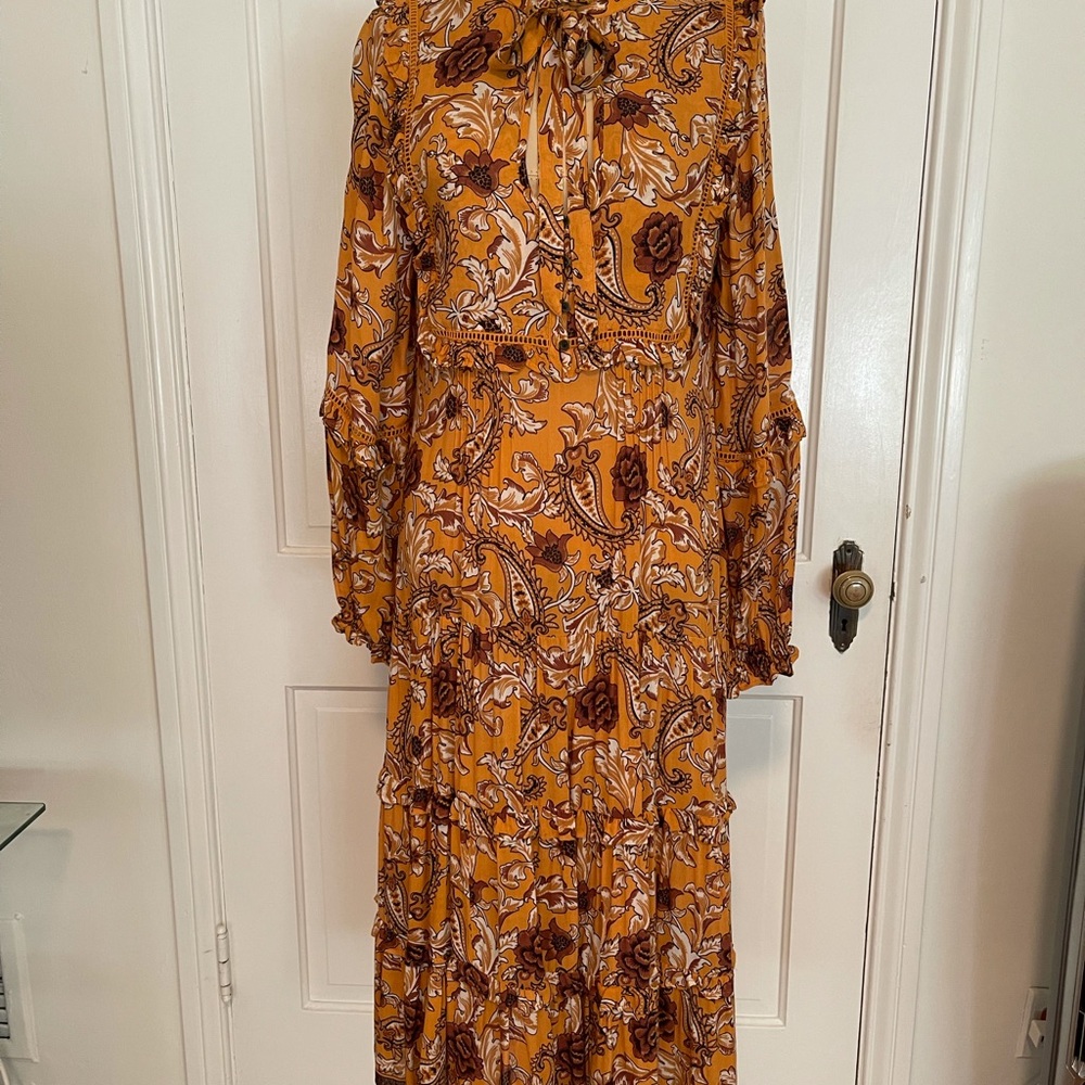 A maxi ruffle dress in a mustard floral print